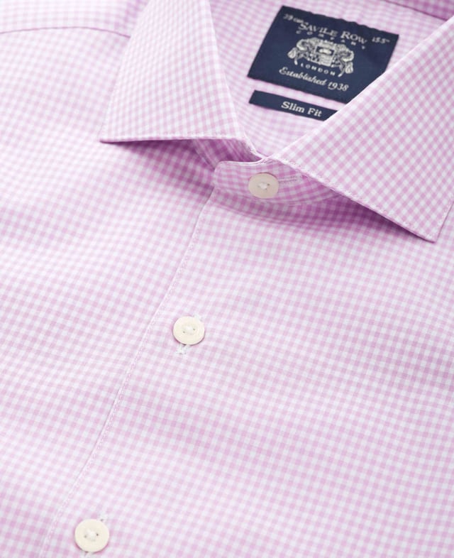 Introducing our bestselling gingham formal shirt in lilac - the perfect addition to your wardrobe for a sophisticated look. Crafted with meticulous attention to detail, this men's shirt offers a sleek silhouette and a timeless design. Slim fit and flattering; gently tapered shape for all builds. Made from 100% BCI cotton poplin and featuers a curl resistant cutaway collar with integral and removable collar stay, and stylish curved edge single cuffs.