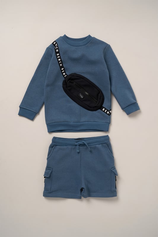 This 2-piece set from Bench includes a standout sweatshirt with a stitched imitation cross body bag detail and matching shorts for a coordinated, streetwear-inspired look. Made from soft brushed sweat fabric and finished with ribbed trims for comfort, it’s an easy go-to for laid-back days. The playful bag detail brings added personality, while the matching shorts complete the look with ease. Perfect for casual wear with a cool, urban edge.