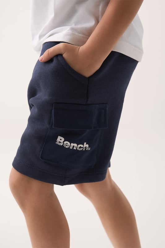 This Bench three-piece set brings together a soft cotton T-shirt, relaxed brushed sweat shorts, and cool sunglasses for an effortless warm-weather look. Ribbed trims and a flat woven drawcord add a practical touch to the laid-back silhouette. Designed for sunny days and easy dressing, it’s the ideal outfit choice for everyday adventures.