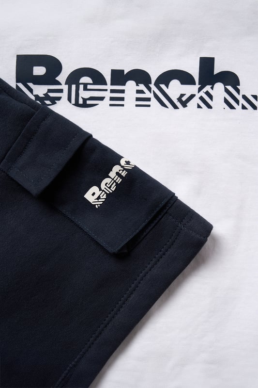 This Bench three-piece set brings together a soft cotton T-shirt, relaxed brushed sweat shorts, and cool sunglasses for an effortless warm-weather look. Ribbed trims and a flat woven drawcord add a practical touch to the laid-back silhouette. Designed for sunny days and easy dressing, it’s the ideal outfit choice for everyday adventures.