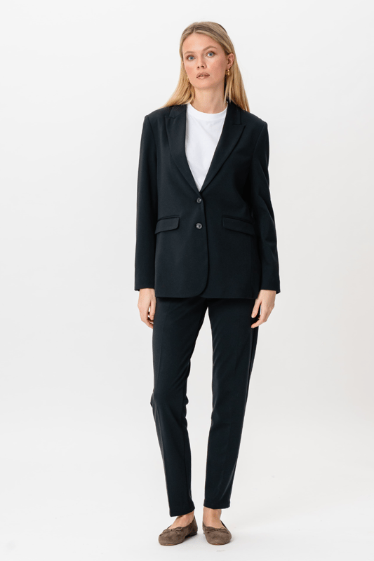 Este Performance Blazer en azul marino es la elección perfecta para las mujeres modernas que desean combinar estilo y comodidad. Está confeccionado para un ajuste perfecto que acentúa tu silueta manteniendo la libertad de movimiento. Diseñado con 75% poliéster, 22% viscosa y 3% elastano, el blazer garantiza una experiencia de uso duradera y cómoda. Este diseño atemporal lo hace adecuado tanto para ocasiones laborales como sociales. Combina la chaqueta con un par de pantalones o un vestido para un look elegante. Es una adición esencial a tu guardarropa, ya que ofrece versatilidad y un aspecto moderno y elegante.