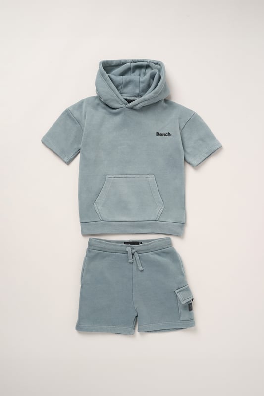 This casual 2-piece set from Bench includes a short sleeve hoody and coordinating shorts, crafted from soft brushed sweat fabric for breathable comfort. The double-lined hood and stretch ribbed finishes deliver a relaxed, sporty vibe with added durability. Perfect for everyday wear, from chilled weekends to active play.