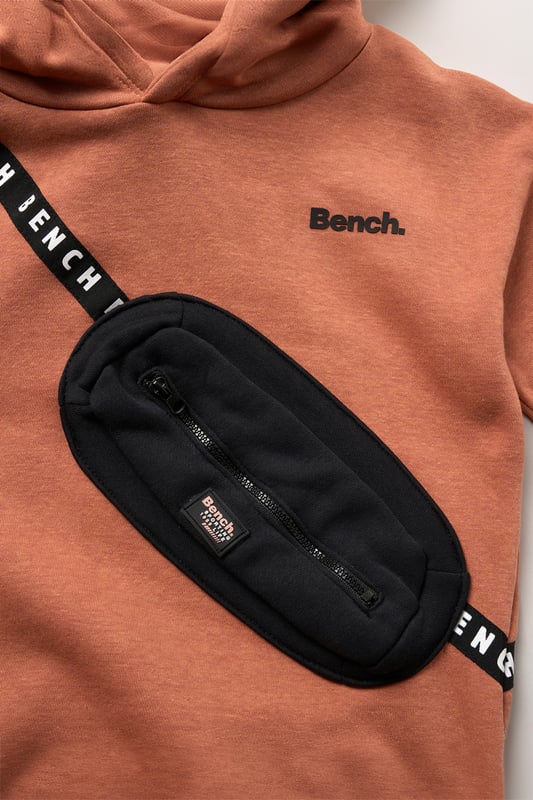This 2-piece set from Bench includes a standout sweatshirt with a stitched imitation cross body bag detail and matching shorts for a coordinated, streetwear-inspired look. Made from soft brushed sweat fabric and finished with ribbed trims for comfort, it’s an easy go-to for laid-back days. The playful bag detail brings added personality, while the matching shorts complete the look with ease. Perfect for casual wear with a cool, urban edge.