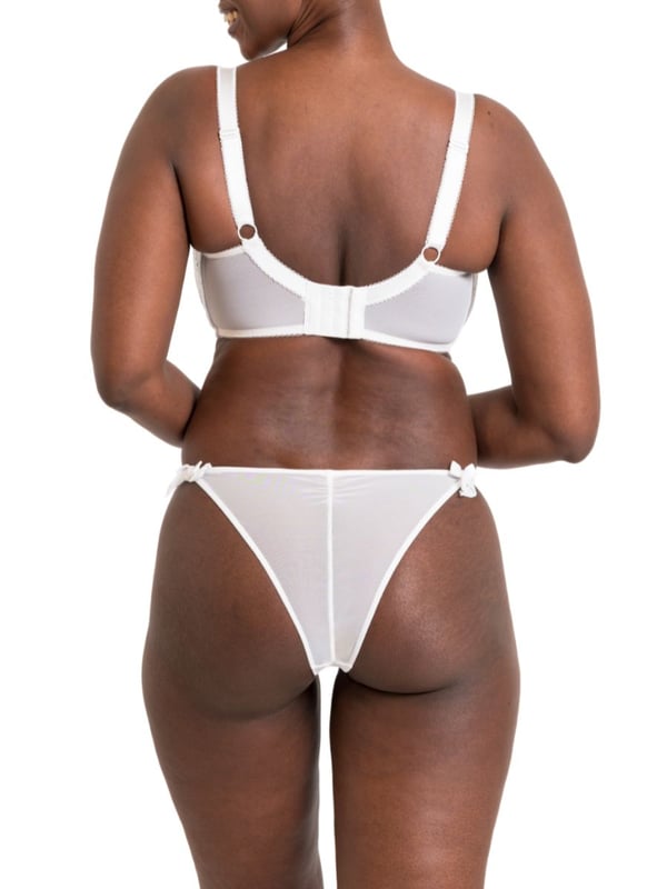 Curvy Kate Flora Balcony Bra. Underwired non padded balcony bra with uplifting vertical seams, broderie anglaise inspired embroidered fabric, cotton trims, scalloped edging and bow detailing. The product is recommended for hand wash only.