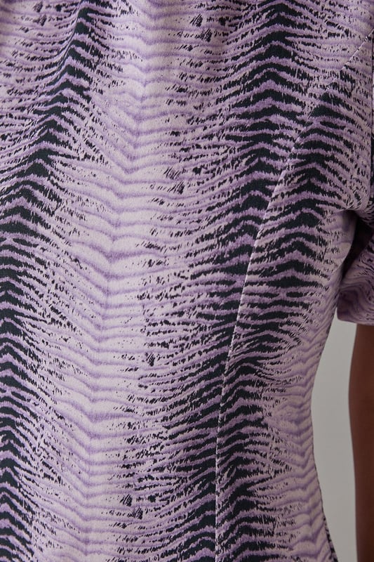 Striking animal print twill fabric with textured finish
        Feminine puff sleeves add volume and contemporary flair
        Tiered ruffle hem creates movement and dimension
        Midi length offers versatile styling options
        Relaxed silhouette with round neckline for effortless comfort
    
    Make a statement in this bold animal print midi dress from Warehouse. The distinctive puff sleeves create a contemporary silhouette while the playful ruffle hem adds movement and feminine charm. The twill fabric provides structure whilst maintaining a comfortable feel for all-day wear. Style with chunky flat sandals as shown for a casual daytime look, or transform for evening gatherings with ankle boots and statement earrings. Perfect for family gatherings or weekend brunches, this dress offers versatility without compromising on style. Layer with a denim jacket when the temperature drops or wear alone to showcase the eye-catching print. The midi length works beautifully with both flats and low heels, making this a truly adaptable addition to your wardrobe.