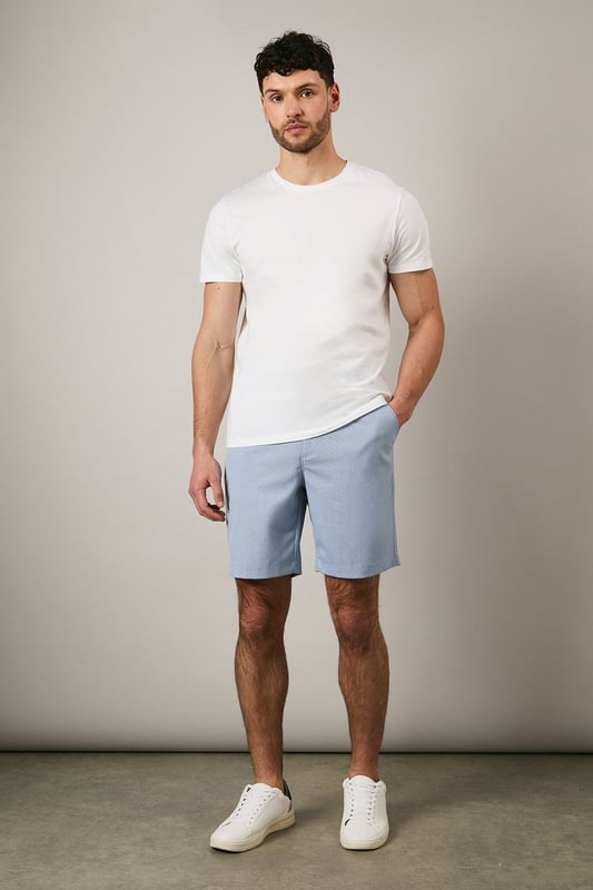 Textured woven fabric adds subtle dimension and visual interest
        Classic chino design with clean-cut finish for versatile styling
        Mid-thigh length offering comfortable coverage
        Flat front design creates a sleek, contemporary silhouette
        Rear pocket detailing for practical everyday wear
    
    These Maine textured chino shorts combine comfort with casual sophistication. The clean lines and tailored fit make them an essential addition to your warm-weather wardrobe. Style them as shown with a crisp white t-shirt and trainers for effortless weekend outings, or pair with a linen shirt and loafers for garden parties and family gatherings. The versatile design transitions seamlessly from daytime casual to evening relaxed events. Perfect for holidays abroad or British summer days, these shorts offer both comfort and style without compromising on quality. The textured fabric adds a refined touch that distinguishes them from ordinary shorts, making them ideal for those who appreciate subtle details in their casual attire.