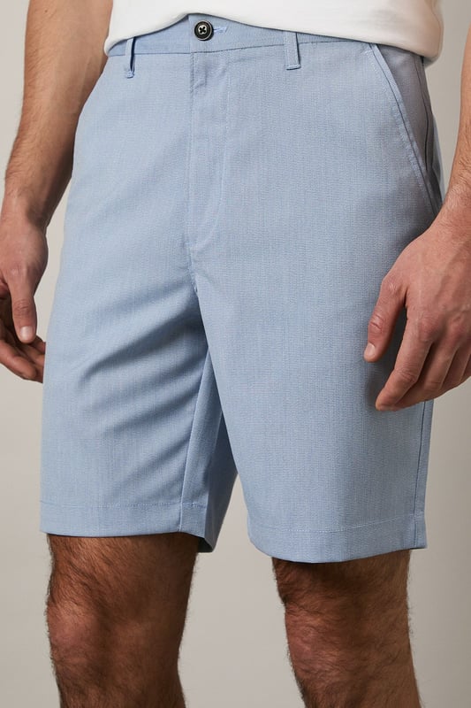 Textured woven fabric adds subtle dimension and visual interest
        Classic chino design with clean-cut finish for versatile styling
        Mid-thigh length offering comfortable coverage
        Flat front design creates a sleek, contemporary silhouette
        Rear pocket detailing for practical everyday wear
    
    These Maine textured chino shorts combine comfort with casual sophistication. The clean lines and tailored fit make them an essential addition to your warm-weather wardrobe. Style them as shown with a crisp white t-shirt and trainers for effortless weekend outings, or pair with a linen shirt and loafers for garden parties and family gatherings. The versatile design transitions seamlessly from daytime casual to evening relaxed events. Perfect for holidays abroad or British summer days, these shorts offer both comfort and style without compromising on quality. The textured fabric adds a refined touch that distinguishes them from ordinary shorts, making them ideal for those who appreciate subtle details in their casual attire.