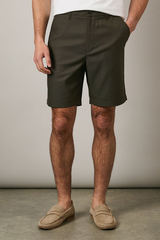 Textured chino shorts with a clean-cut silhouette for a refined casual look
        Classic flat front design with side pockets for practicality
        Mid-thigh length offering comfortable coverage for warm-weather wear
        Belt loops provide styling versatility to suit your personal taste
        Tailored waistband with button fastening ensures a secure and comfortable fit
    
    These Maine textured chino shorts combine comfort with understated style for your casual wardrobe. The versatile design makes them perfect for weekend outings, garden parties or relaxed family gatherings. Style them as shown with a crisp white t-shirt and patterned short-sleeve shirt for an effortlessly coordinated look, or pair with a simple polo for more laid-back occasions. The neutral tone works brilliantly with loafers or boat shoes for a smart-casual approach, while trainers create a more relaxed aesthetic. These shorts transition seamlessly from daytime casual to evening barbecues - simply add a lightweight knit when temperatures drop. Their adaptable nature makes them an essential component for building numerous summer outfits with minimal effort.