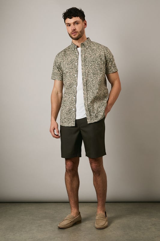 Textured chino shorts with a clean-cut silhouette for a refined casual look
        Classic flat front design with side pockets for practicality
        Mid-thigh length offering comfortable coverage for warm-weather wear
        Belt loops provide styling versatility to suit your personal taste
        Tailored waistband with button fastening ensures a secure and comfortable fit
    
    These Maine textured chino shorts combine comfort with understated style for your casual wardrobe. The versatile design makes them perfect for weekend outings, garden parties or relaxed family gatherings. Style them as shown with a crisp white t-shirt and patterned short-sleeve shirt for an effortlessly coordinated look, or pair with a simple polo for more laid-back occasions. The neutral tone works brilliantly with loafers or boat shoes for a smart-casual approach, while trainers create a more relaxed aesthetic. These shorts transition seamlessly from daytime casual to evening barbecues - simply add a lightweight knit when temperatures drop. Their adaptable nature makes them an essential component for building numerous summer outfits with minimal effort.