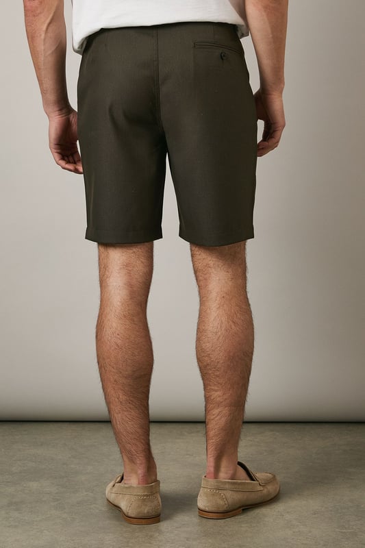 Textured chino shorts with a clean-cut silhouette for a refined casual look
        Classic flat front design with side pockets for practicality
        Mid-thigh length offering comfortable coverage for warm-weather wear
        Belt loops provide styling versatility to suit your personal taste
        Tailored waistband with button fastening ensures a secure and comfortable fit
    
    These Maine textured chino shorts combine comfort with understated style for your casual wardrobe. The versatile design makes them perfect for weekend outings, garden parties or relaxed family gatherings. Style them as shown with a crisp white t-shirt and patterned short-sleeve shirt for an effortlessly coordinated look, or pair with a simple polo for more laid-back occasions. The neutral tone works brilliantly with loafers or boat shoes for a smart-casual approach, while trainers create a more relaxed aesthetic. These shorts transition seamlessly from daytime casual to evening barbecues - simply add a lightweight knit when temperatures drop. Their adaptable nature makes them an essential component for building numerous summer outfits with minimal effort.