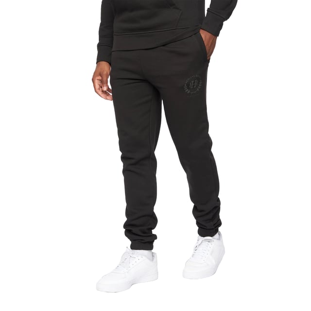 65% Baumwolle, 35% Polyester. Gewebe: angerautes Material. Design: Tintendruck, Logo, Aufschrift. Zum Überziehen. Hi-Build. Taschenart: Zwei Seitentaschen. Taille: Elastisch. Bündchen: Elastisch.