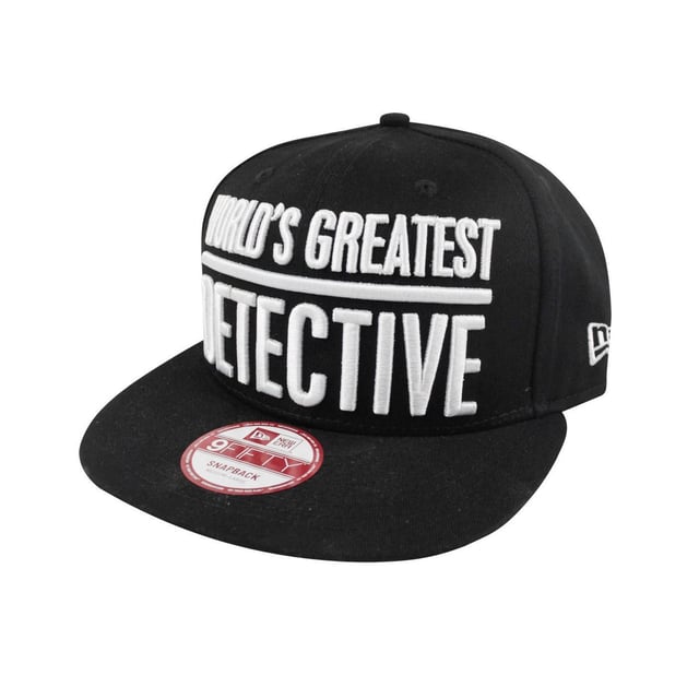 An official New Era 9FIFTY Batman AKA snapback cap. Comes in solid black with a light grey under visor and matching grey adjustable strap. Features a large embroidered design across the front of the cap reading Worlds Greatest Detective in crisp white. Has a high quality feel and finish making it a striking look against the classic black of the cap. Also sees the iconic Batman logo in yellow and black embroidered along the side. The official New Era logo can also be seen across the side in white along with the official sticker across the flat peak. Also benefits from an interior branded taping as well as a moisture wicking black sweatband. Fitted and has an open adjustable back. Officially licensed merchandise. Made with 100% cotton.