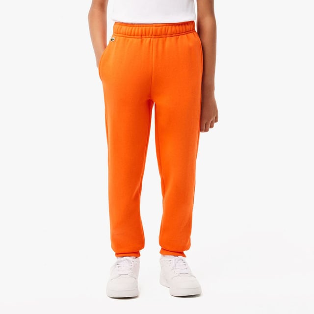 Fleece Sweatbroek Organisch geborsteld katoenen fleece en gerecycled polyester Verborgen zijzakken Elastische taille met trekkoord Elastische enkels voor betere pasvorm Geborduurde krokodil