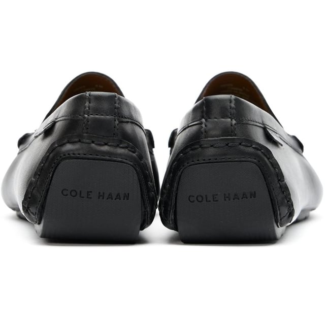 Mens black Cole Haan driving shoes, manufactured with leather and a rubber sole. Featuring: elastic side gusset, cole haan branding, soft leather, padded insole and driving sole.