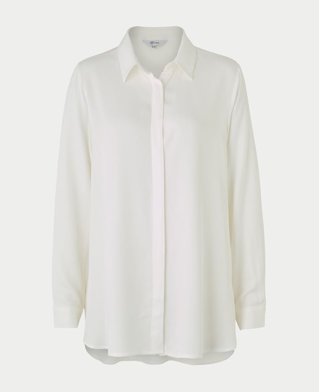 Elevate your everyday wardrobe with this off-white viscose twill boyfriend-fit shirt that exudes understated luxury. Its silky-soft fabric is light yet durable, flowing effortlessly as you move. The clean lines of the small collar and fly-front give it a minimalist chic vibe, while the scooped hem lends a casual, relaxed finish. Perfectly versatile, it can be tucked into tailored trousers for a polished look or left loose over your favorite jeans for a laid-back, elegant feel. Its neutral tone makes it the perfect layering piece. 100% viscose twill, soft and drapey. Small neat collar. Fly front concealed buttons. Scooped hem. Boyfriend fit. Long sleeves with single buttoned cuff. Wash at 30°C on a gentle cycle.