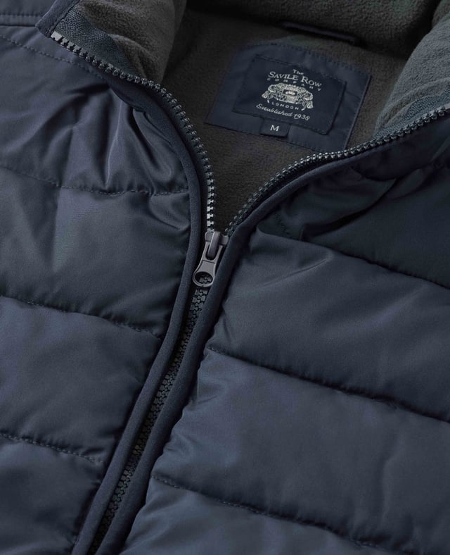 A sustainable choice, this quilted gilet is made using recycled fabrics, including the padding. There's multiple pockets to keep your essentials safe, while the back is cut a little longer than the front to avoid gaping. Tunnel quilted showerproof 100% ocean recycled polyester outer.  Eco friendly down-like 230g wadding for good insulation without the weight.  Lined in 100% grey polyester microfleece.  Outside 2 zipped welt pockets, inside one chest pocket.  Back is a little longer than front.  Funnel neck with front zip.  Centre back length on a size Medium is 72.5cm.  Can be dry cleaned.  Presented in fully recyclable packaging.