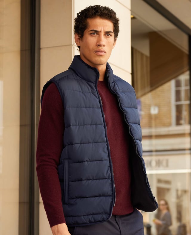A sustainable choice, this quilted gilet is made using recycled fabrics, including the padding. There's multiple pockets to keep your essentials safe, while the back is cut a little longer than the front to avoid gaping. Tunnel quilted showerproof 100% ocean recycled polyester outer.  Eco friendly down-like 230g wadding for good insulation without the weight.  Lined in 100% grey polyester microfleece.  Outside 2 zipped welt pockets, inside one chest pocket.  Back is a little longer than front.  Funnel neck with front zip.  Centre back length on a size Medium is 72.5cm.  Can be dry cleaned.  Presented in fully recyclable packaging.