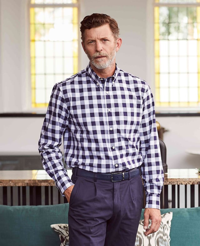 This men's casual shirt features a bold navy and white check design. It's made from 100% BCI cotton in a luxurious fine twill weave and features a classic button-down collar. The classic fit shape offers plenty of room for movement.