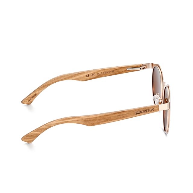 Earth Wood Reine Polarized Sunglasses - Walnut/Brown Frame: Rose Gold Metal ; Arm: Walnut Wood; Earpiece: Walnut Wood; Lens: Brown Multi-Layer Triacetate Cellulose (TAC); Mirrored Lens: No; Gradient Lens: No; Polarization: Optical Quality; UV Protection: 100% UVA/UVB; Hinge: Spring Loaded Stainless Steel; Adjustable Nosepads: Yes; Lens Width: 60mm; Temple Length: 148mm; Bridge Width: 20mm.