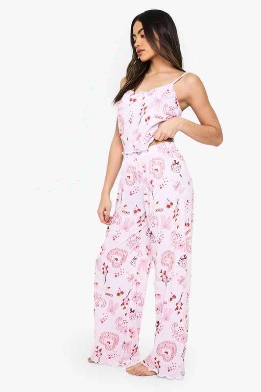 Charming all-over print featuring playful motifs
        Comfortable knitted fabric for a soft feel
        Adjustable spaghetti straps for a customised fit
        Wide-leg trousers for unrestricted movement
        Versatile two-piece set for mix-and-match styling
    
    Drift off to dreamland in style with this delightful nightwear set from Boohoo. The charming all-over print adds a touch of whimsy to your bedtime routine, while the knitted fabric ensures a cosy night's sleep. The adjustable spaghetti straps allow you to find your perfect fit, and the wide-leg trousers offer ample room for movement as you lounge or slumber. This versatile set is perfect for those warm summer nights when you want to feel cool and comfortable. Pair the top with your favourite pyjama bottoms or wear the trousers with a simple vest for a mix-and-match look. Whether you're having a leisurely weekend lie-in or getting ready for a girls' night in, this adorable set will keep you feeling relaxed and looking effortlessly chic.