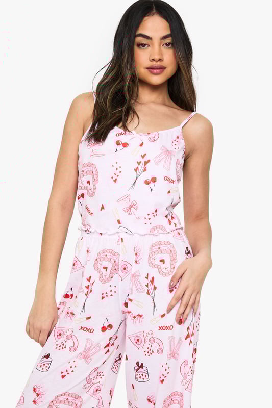 Charming all-over print featuring playful motifs
        Comfortable knitted fabric for a soft feel
        Adjustable spaghetti straps for a customised fit
        Wide-leg trousers for unrestricted movement
        Versatile two-piece set for mix-and-match styling
    
    Drift off to dreamland in style with this delightful nightwear set from Boohoo. The charming all-over print adds a touch of whimsy to your bedtime routine, while the knitted fabric ensures a cosy night's sleep. The adjustable spaghetti straps allow you to find your perfect fit, and the wide-leg trousers offer ample room for movement as you lounge or slumber. This versatile set is perfect for those warm summer nights when you want to feel cool and comfortable. Pair the top with your favourite pyjama bottoms or wear the trousers with a simple vest for a mix-and-match look. Whether you're having a leisurely weekend lie-in or getting ready for a girls' night in, this adorable set will keep you feeling relaxed and looking effortlessly chic.