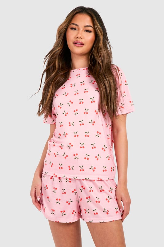 Playful cherry print pyjama set featuring a relaxed t-shirt top and matching shorts
        Soft jersey fabric ensures maximum comfort for lounging and sleeping
        Round neckline and short sleeves offer a classic, fuss-free silhouette
        Loose-fitting shorts with an elasticated waistband for unrestricted movement
        Versatile two-piece design perfect for year-round nightwear
    
    Add a touch of whimsy to your nightwear collection with this charming cherry print pyjama set from Boohoo. The relaxed t-shirt style top pairs perfectly with the comfortable shorts for a coordinated bedtime look that's both cute and practical. The lightweight jersey fabric feels wonderfully soft against the skin, making this set ideal for a restful night's sleep or lazy weekend mornings. Style with fluffy slippers and a cosy dressing gown during cooler months, or wear on its own during warmer weather. This playful set also makes for a delightful gift option or a treat for yourself when your nightwear drawer needs a refresh. The timeless silhouette and fun print reflect Boohoo's commitment to creating fashion that's both accessible and on-trend, ensuring you look stylish even when you're winding down.