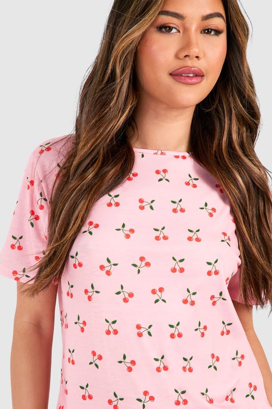 Playful cherry print pyjama set featuring a relaxed t-shirt top and matching shorts
        Soft jersey fabric ensures maximum comfort for lounging and sleeping
        Round neckline and short sleeves offer a classic, fuss-free silhouette
        Loose-fitting shorts with an elasticated waistband for unrestricted movement
        Versatile two-piece design perfect for year-round nightwear
    
    Add a touch of whimsy to your nightwear collection with this charming cherry print pyjama set from Boohoo. The relaxed t-shirt style top pairs perfectly with the comfortable shorts for a coordinated bedtime look that's both cute and practical. The lightweight jersey fabric feels wonderfully soft against the skin, making this set ideal for a restful night's sleep or lazy weekend mornings. Style with fluffy slippers and a cosy dressing gown during cooler months, or wear on its own during warmer weather. This playful set also makes for a delightful gift option or a treat for yourself when your nightwear drawer needs a refresh. The timeless silhouette and fun print reflect Boohoo's commitment to creating fashion that's both accessible and on-trend, ensuring you look stylish even when you're winding down.