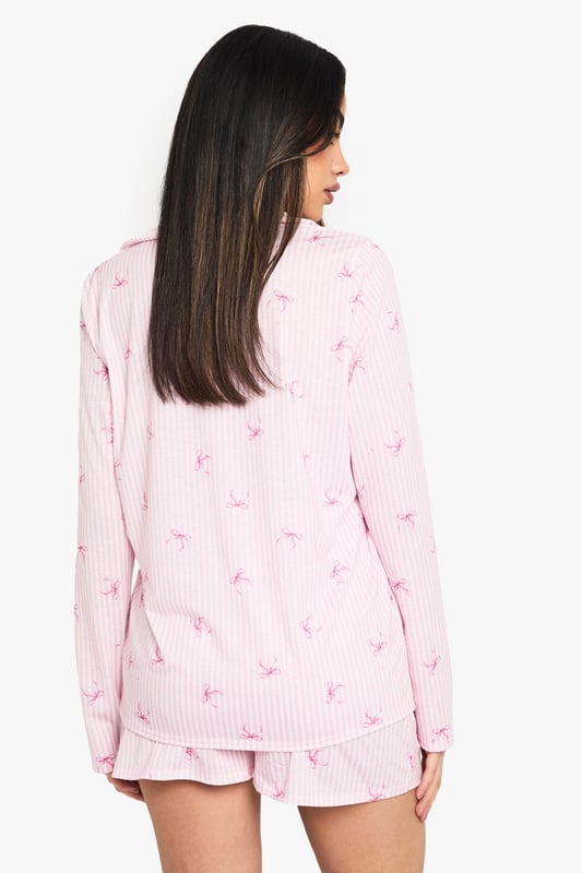 Charming striped pattern with delicate motif print
        Long-sleeved shirt with notched collar for a classic look
        Comfortable knitted fabric for cosy nights
        Matching shorts with relaxed fit
        Versatile two-piece set for mix-and-match styling
    
    Drift off to dreamland in style with this enchanting pyjama set from Boohoo. The long-sleeved shirt boasts a charming striped pattern adorned with a delicate motif print, adding a touch of whimsy to your nighttime routine. Crafted from soft knitted fabric, this set promises ultimate comfort for those lazy mornings and cosy nights in. The relaxed fit shorts complete the ensemble, offering versatility for warmer evenings. Perfect for lounging, this set can be easily mixed and matched with other nightwear pieces in your collection. Whether you're having a girls' night in or treating yourself to a pamper session, this pyjama set will keep you feeling fabulous and relaxed. Pair with fluffy slippers and a warm dressing gown for the ultimate night-in ensemble.