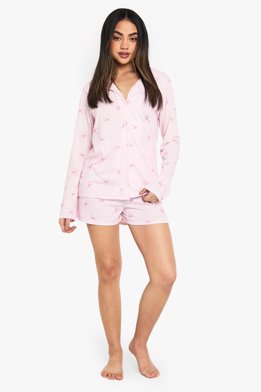 Charming striped pattern with delicate motif print
        Long-sleeved shirt with notched collar for a classic look
        Comfortable knitted fabric for cosy nights
        Matching shorts with relaxed fit
        Versatile two-piece set for mix-and-match styling
    
    Drift off to dreamland in style with this enchanting pyjama set from Boohoo. The long-sleeved shirt boasts a charming striped pattern adorned with a delicate motif print, adding a touch of whimsy to your nighttime routine. Crafted from soft knitted fabric, this set promises ultimate comfort for those lazy mornings and cosy nights in. The relaxed fit shorts complete the ensemble, offering versatility for warmer evenings. Perfect for lounging, this set can be easily mixed and matched with other nightwear pieces in your collection. Whether you're having a girls' night in or treating yourself to a pamper session, this pyjama set will keep you feeling fabulous and relaxed. Pair with fluffy slippers and a warm dressing gown for the ultimate night-in ensemble.