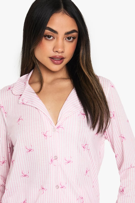 Charming striped pattern with delicate motif print
        Long-sleeved shirt with notched collar for a classic look
        Comfortable knitted fabric for cosy nights
        Matching shorts with relaxed fit
        Versatile two-piece set for mix-and-match styling
    
    Drift off to dreamland in style with this enchanting pyjama set from Boohoo. The long-sleeved shirt boasts a charming striped pattern adorned with a delicate motif print, adding a touch of whimsy to your nighttime routine. Crafted from soft knitted fabric, this set promises ultimate comfort for those lazy mornings and cosy nights in. The relaxed fit shorts complete the ensemble, offering versatility for warmer evenings. Perfect for lounging, this set can be easily mixed and matched with other nightwear pieces in your collection. Whether you're having a girls' night in or treating yourself to a pamper session, this pyjama set will keep you feeling fabulous and relaxed. Pair with fluffy slippers and a warm dressing gown for the ultimate night-in ensemble.
