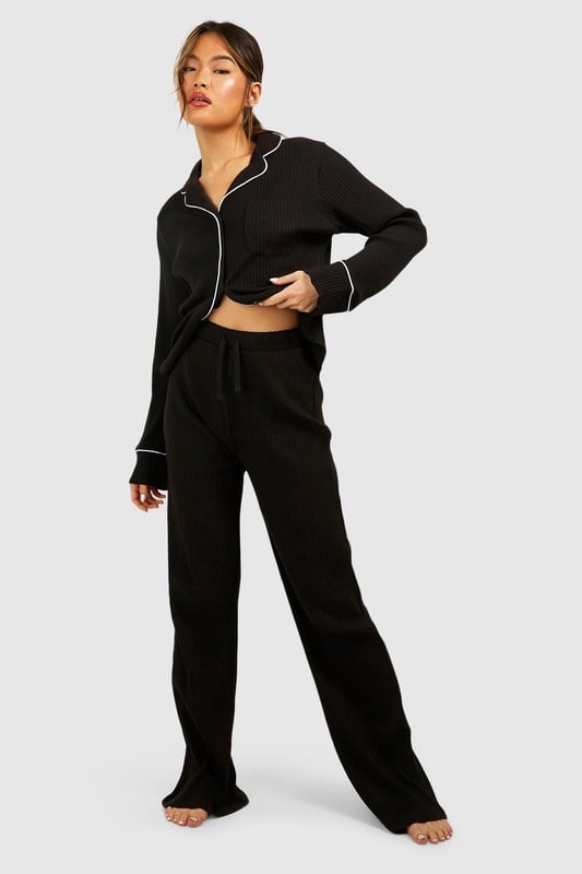 Ribbed jersey fabric for comfort and texture
        Tie waist detail for adjustable fit
        Wide-leg design for relaxed silhouette
        Matching cropped jacket with contrasting piping
        Versatile two-piece set for effortless lounging
    
    Embrace laid-back luxury with this rib tie waist lounge trouser set from Boohoo. Perfect for those cosy nights in or lazy weekend mornings, this ensemble offers both style and comfort. The wide-leg trousers feature a flattering high waist with an adjustable tie, allowing you to customise your fit. Pair with the matching cropped jacket, adorned with chic contrasting piping, for a coordinated look that's anything but ordinary. Whether you're binge-watching your favourite series or hosting an intimate brunch at home, this set will keep you feeling fabulous and relaxed. Style with soft slippers and your favourite oversized cardigan for ultimate comfort, or dress it up with statement earrings and a messy bun for those impromptu video calls. This Boohoo loungewear set is the epitome of effortless chic, ensuring you look put-together even on your most casual days.