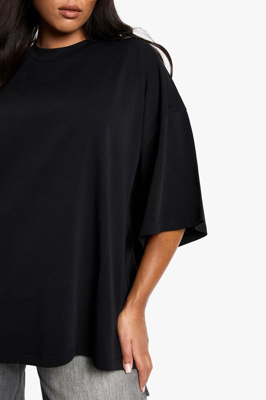 Super oversized fit for maximum comfort and contemporary style
        Crafted from soft cotton fabric for all-day wearability
        Relaxed dropped shoulders and roomy elbow-length sleeves
        Clean, minimalist design with a subtle crew neckline
        Generous length providing versatile styling options
    
    Make a bold statement with this super oversized cotton T-shirt from Boohoo. The relaxed silhouette creates an effortlessly cool vibe that works brilliantly with slim-fit bottoms for a balanced look. As seen on our model, pair with light grey joggers or leggings for casual daytime outings. The generous proportions allow for various styling options-try a half-tuck at the front with high-waisted jeans, or layer over cycling shorts for an on-trend ensemble. Perfect for casual coffee dates, weekend shopping trips, or lounging at home in style. The versatile design transitions seamlessly from day to night-simply add statement jewellery and trainers for an elevated casual look. This T-shirt embodies the laid-back yet fashion-forward aesthetic that's essential for your everyday wardrobe.