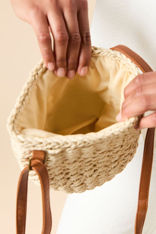 Intricately woven rattan bucket bag with distinctive open-weave pattern
        Contrasting leather shoulder strap for comfortable cross-body wear
        Spacious interior with synthetic lining for practicality
        Compact yet roomy design perfect for everyday essentials
        Authentic natural texture that adds artisanal charm to any outfit
    
    The Sara Rattan Detail Bucket Bag from Oasis combines natural texture with feminine charm. The beautifully crafted woven exterior showcases intricate detailing, whilst the leather strap adds a touch of sophistication and durability. Style this versatile piece with a crisp white broderie anglaise dress for garden parties, or pair with relaxed linen trousers and a simple tee for weekend brunches. The bucket silhouette offers ample space for your mobile, wallet and beauty essentials without overwhelming your look. This bag transitions effortlessly from daytime shopping trips to casual evening meals, making it a wardrobe staple for the warmer months. The neutral tones complement virtually any ensemble, allowing this charming accessory to become your go-to companion for family gatherings and casual outings alike.