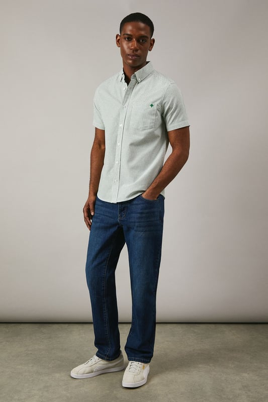Classic Oxford stripe pattern for timeless appeal
        Short sleeves ideal for warmer weather
        Button-down collar for a smart-casual look
        Chest pocket with embroidered logo detail
        Back pleat for enhanced comfort and movement
    
    This Maine Oxford stripe short sleeve shirt is a versatile addition to any gentleman's wardrobe. The crisp woven fabric and classic stripe pattern create a smart yet relaxed aesthetic, perfect for various casual occasions. Style it effortlessly with dark denim jeans and white trainers for a laid-back weekend look, or pair it with chino shorts and boat shoes for a seaside stroll. The button-down collar adds a touch of refinement, making it suitable for casual Fridays at the office when worn with tailored trousers. Whether you're attending a family barbecue, meeting friends for a pub lunch, or enjoying a sunny day out, this shirt offers both comfort and style. Its breathable cotton composition ensures you stay cool and collected, while the back pleat allows for ease of movement. Embrace the timeless charm of this Oxford shirt and make it your go-to for effortless, British casual style.