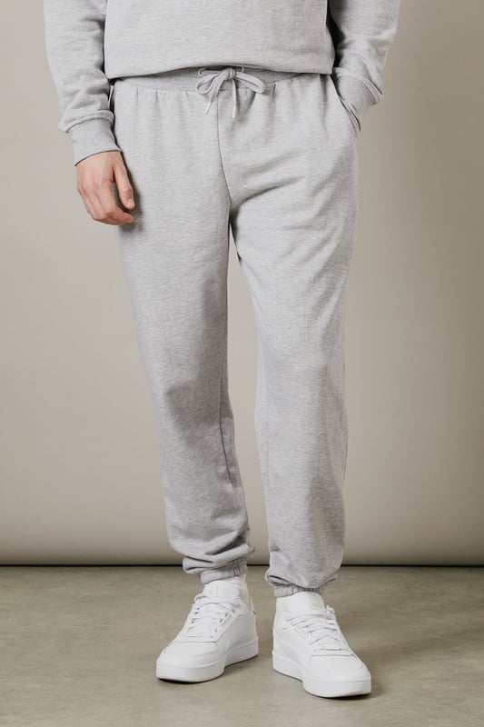 Soft jersey fabric for all-day comfort and ease of movement
        Relaxed fit through the leg with tapered ankle cuffs
        Adjustable drawstring waist for a customised fit
        Side pockets for practicality and casual styling
        Versatile design that pairs effortlessly with both casual and athleisure wear
    
    These classic jersey joggers deliver the perfect balance of comfort and style for the modern man. The relaxed silhouette offers unrestricted movement while the tapered ankle creates a more refined finish than traditional tracksuit bottoms. As demonstrated by our model, they pair brilliantly with a matching quarter-zip sweatshirt and crisp white trainers for a coordinated look that works for weekend errands or meeting mates at the local. The soft jersey fabric makes these joggers ideal for lounging at home, but they're equally suited to casual outings or sports activities. Their understated design means they'll integrate seamlessly into your existing wardrobe, working well with everything from simple t-shirts to lightweight jackets when the weather turns. A true wardrobe essential that combines practicality with laid-back style.