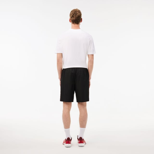 Diamond Taffeta Tennis Shorts Recycled polyester diamond taffeta  limiting the production of virgin materials Regular  straight cut Adjustable drawstring waist Short cut: crotch height 21 cm Silicone crocodile on side