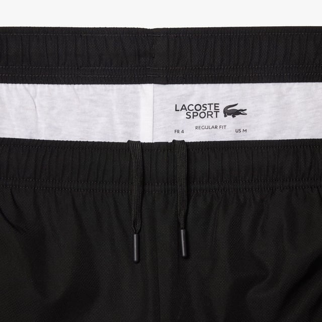 Diamond Taffeta Tennis Shorts Recycled polyester diamond taffeta  limiting the production of virgin materials Regular  straight cut Adjustable drawstring waist Short cut: crotch height 21 cm Silicone crocodile on side