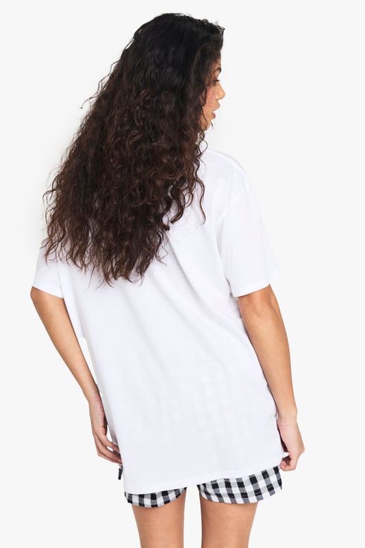 Oversized fit for ultimate comfort and laid-back style
        Bold NYC Athletics Dept graphic print for a sporty urban vibe
        Versatile cotton fabric suitable for all-day wear
        Short sleeves and crew neckline for a classic T-shirt silhouette
        Relaxed dropped shoulders enhancing the casual look
    
    Embrace the urban-chic aesthetic with this oversized T-shirt featuring a striking NYC Athletics Dept print. Perfect for those seeking a blend of comfort and style, this versatile piece is ideal for casual outings or relaxed weekends. Pair it with gingham shorts as shown for a playful contrast, or style it with your favourite denim for an effortless everyday look. The roomy fit allows for easy layering - throw on a denim jacket for cooler evenings or wear it over a long-sleeved top when the temperature drops. Dress it up with a leather skirt and trainers for a trendy night out, or keep it casual with joggers for a quick coffee run. This T-shirt is a must-have for the fashion-forward individual who values both comfort and street-style credibility.