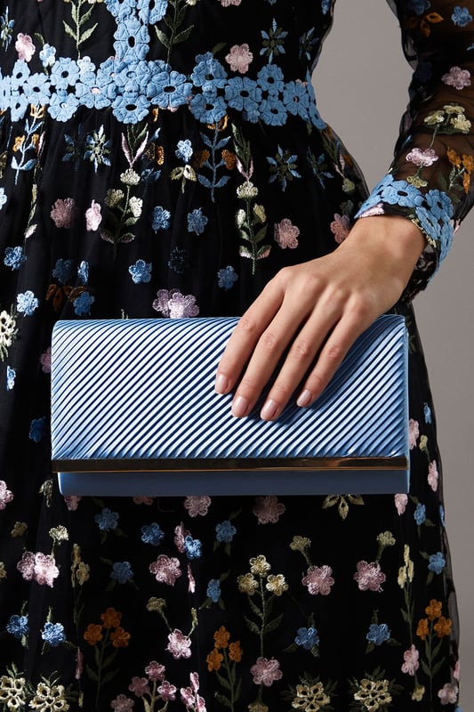 Elegant satin clutch bag with pleated detailing
        Versatile design suitable for various formal occasions
        Sleek and compact size perfect for essentials
        Sophisticated texture adds a luxurious touch
        Ideal complement to Coast's occasion wear collection
    
    The Daisy Satin Pleated Detail Clutch Bag is the epitome of refined elegance, designed to accompany you to life's most special moments. Whether you're attending a wedding, heading to the races, or celebrating a milestone, this clutch will be your trusted companion. Its pleated detailing adds a touch of texture and visual interest, while the compact size ensures you can carry your essentials with ease. Style it with a flowing maxi dress and strappy heels for a garden party, or pair it with a tailored jumpsuit for a more contemporary evening look. The versatile design allows for seamless transition from day to night events, making it a valuable addition to your occasion wear wardrobe. For those who appreciate quality and sophistication, this Coast clutch bag is an investment piece that will serve you well for seasons to come.