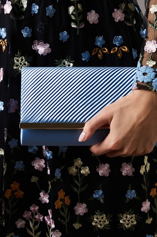 Elegant satin clutch bag with pleated detailing
        Versatile design suitable for various formal occasions
        Sleek and compact size perfect for essentials
        Sophisticated texture adds a luxurious touch
        Ideal complement to Coast's occasion wear collection
    
    The Daisy Satin Pleated Detail Clutch Bag is the epitome of refined elegance, designed to accompany you to life's most special moments. Whether you're attending a wedding, heading to the races, or celebrating a milestone, this clutch will be your trusted companion. Its pleated detailing adds a touch of texture and visual interest, while the compact size ensures you can carry your essentials with ease. Style it with a flowing maxi dress and strappy heels for a garden party, or pair it with a tailored jumpsuit for a more contemporary evening look. The versatile design allows for seamless transition from day to night events, making it a valuable addition to your occasion wear wardrobe. For those who appreciate quality and sophistication, this Coast clutch bag is an investment piece that will serve you well for seasons to come.