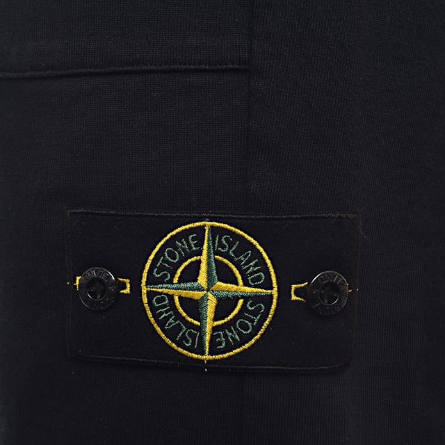 Authenticity Guaranteed - All Stone Island products feature a unique QR code for instant verification of authenticity. Stone Island Fleece Bermuda Shorts
       â€¢ Brand: Stone Island
       â€¢ Material: 100%Cotton
       â€¢ Design: Made from premium soft cotton fleece for superior comfort. These shorts feature an elastic waistband with an internal drawstring, side pockets, a single back pocket, and the signature Stone Island compass patch on the left leg. The fabric offers a plush, breathable feel perfect for everyday wear
       â€¢ Colour: Blue
       â€¢ Style: Athleisure-inspired with a clean silhouette, great for lounging, streetwear, or summer layering