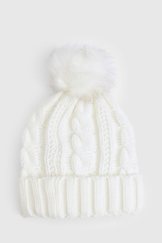 Chunky cable knit design for a classic winter look
        Soft acrylic fabric for comfort and warmth
        Oversized faux fur pom-pom for a playful touch
        Ribbed cuff for a snug fit
        Versatile one-size-fits-all styling
    
    Embrace the chilly weather with this charming Cable Knit Faux Pom Beanie from Boohoo. The chunky cable knit pattern adds a timeless appeal, while the oversized faux fur pom-pom injects a dash of fun to your winter ensemble. Perfect for casual outings or family gatherings, this beanie pairs effortlessly with your favourite jumper and jeans combo. For a trendy look, team it with a longline puffer coat, thermal leggings, and chunky trainers. The versatile design makes it an ideal accessory for various cold-weather activities, from ice skating with friends to cosy walks in the park. With its soft acrylic fabric and snug fit, this beanie ensures you stay warm and stylish throughout the season.