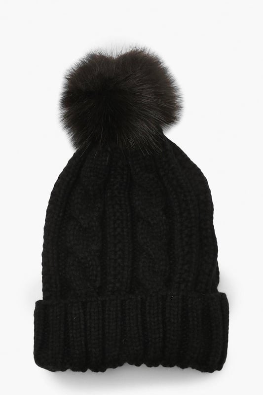 Chunky cable knit design for a classic winter look
        Soft acrylic fabric for comfort and warmth
        Oversized faux fur pom-pom for a playful touch
        Ribbed cuff for a snug fit
        Versatile one-size-fits-all styling
    
    Embrace the chilly weather with this charming Cable Knit Faux Pom Beanie from Boohoo. The chunky cable knit pattern adds a timeless appeal, while the oversized faux fur pom-pom injects a dash of fun to your winter ensemble. Perfect for casual outings or family gatherings, this beanie pairs effortlessly with your favourite jumper and jeans combo. For a trendy look, team it with a longline puffer coat, thermal leggings, and chunky trainers. The versatile design makes it an ideal accessory for various cold-weather activities, from ice skating with friends to cosy walks in the park. With its soft acrylic fabric and snug fit, this beanie ensures you stay warm and stylish throughout the season.
