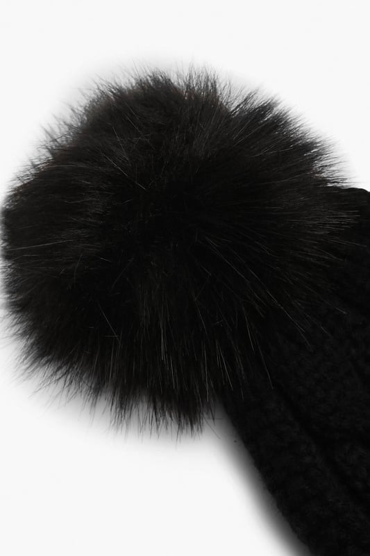 Chunky cable knit design for a classic winter look
        Soft acrylic fabric for comfort and warmth
        Oversized faux fur pom-pom for a playful touch
        Ribbed cuff for a snug fit
        Versatile one-size-fits-all styling
    
    Embrace the chilly weather with this charming Cable Knit Faux Pom Beanie from Boohoo. The chunky cable knit pattern adds a timeless appeal, while the oversized faux fur pom-pom injects a dash of fun to your winter ensemble. Perfect for casual outings or family gatherings, this beanie pairs effortlessly with your favourite jumper and jeans combo. For a trendy look, team it with a longline puffer coat, thermal leggings, and chunky trainers. The versatile design makes it an ideal accessory for various cold-weather activities, from ice skating with friends to cosy walks in the park. With its soft acrylic fabric and snug fit, this beanie ensures you stay warm and stylish throughout the season.