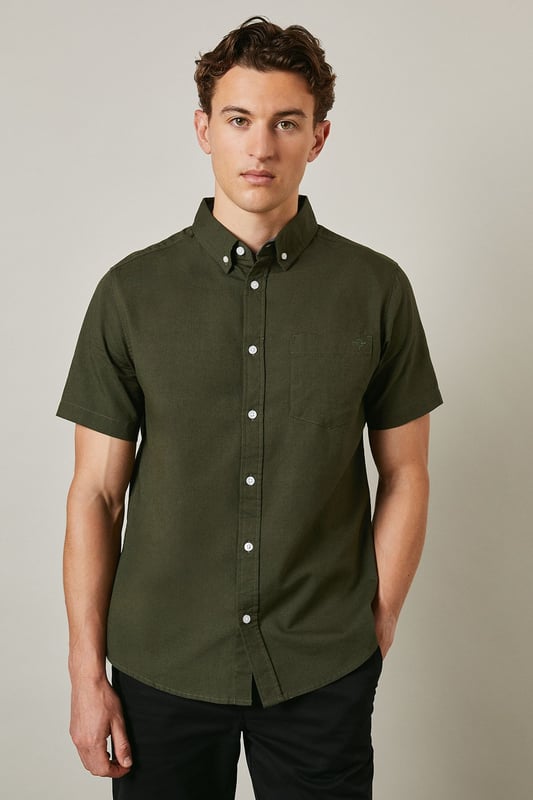 Textured woven cotton fabric with subtle surface detail for added visual interest
        Classic button-down collar with short sleeves for warm-weather comfort
        Clean-cut design featuring a single back pleat for improved movement
        Traditional front button fastening with contrasting white buttons
        Versatile regular fit that suits a variety of body types
    
    This Maine textured short sleeve shirt combines timeless style with everyday practicality. The breathable cotton construction ensures all-day comfort whilst the subtle texture adds character to this wardrobe essential. Perfect for casual weekend outings, pair it with dark shorts and white trainers as shown for an effortlessly cool summer look. The versatile design also works brilliantly with chinos or jeans for family gatherings or informal social events. Layer under a lightweight jacket when the temperature drops or wear it unbuttoned over a plain t-shirt for a more relaxed approach. The button-down collar maintains a smart appearance even without a tie, making this shirt an ideal choice for those occasions that sit between casual and smart-casual. Machine washable at 30 degrees, it's designed to maintain its shape and appearance with proper care.