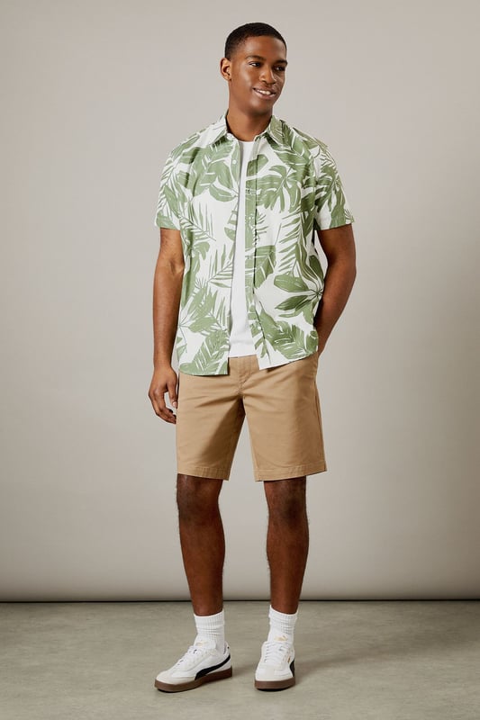 Bold leaf print design for a distinctive summer look
        Short sleeve construction with classic collar for casual comfort
        Button-through front with chest pocket detail
        Crafted from 100% cotton for breathable all-day wear
        Regular fit silhouette that suits most body types
    
    This Burton leaf print shirt brings a touch of tropical flair to your casual wardrobe without compromising on comfort. Perfect for warm-weather socialising, it pairs brilliantly with chino shorts and white trainers as shown for daytime pub garden gatherings. The versatile design works equally well with neutral trousers for evening drinks or family barbecues. The breathable cotton fabric ensures you'll stay comfortable throughout the day, whilst the classic cut maintains a smart-casual balance that Burton is known for. Layer under a lightweight bomber jacket when the temperature drops, or wear open over a plain white t-shirt for a relaxed weekend look. Machine washable at 30 degrees, this shirt combines practicality with effortless style for the modern British man who values both tradition and contemporary design.