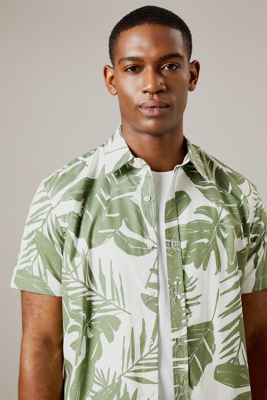 Bold leaf print design for a distinctive summer look
        Short sleeve construction with classic collar for casual comfort
        Button-through front with chest pocket detail
        Crafted from 100% cotton for breathable all-day wear
        Regular fit silhouette that suits most body types
    
    This Burton leaf print shirt brings a touch of tropical flair to your casual wardrobe without compromising on comfort. Perfect for warm-weather socialising, it pairs brilliantly with chino shorts and white trainers as shown for daytime pub garden gatherings. The versatile design works equally well with neutral trousers for evening drinks or family barbecues. The breathable cotton fabric ensures you'll stay comfortable throughout the day, whilst the classic cut maintains a smart-casual balance that Burton is known for. Layer under a lightweight bomber jacket when the temperature drops, or wear open over a plain white t-shirt for a relaxed weekend look. Machine washable at 30 degrees, this shirt combines practicality with effortless style for the modern British man who values both tradition and contemporary design.