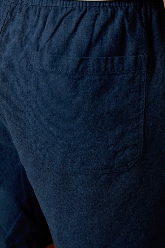 Textured woven fabric with distinctive marl finish for added visual interest
        Comfortable elasticated waistband for an easy, relaxed fit
        Practical back pocket for essential items
        Mid-thigh length offering the perfect balance between comfort and style
        Versatile navy hue that pairs effortlessly with your existing wardrobe
    
    These Burton textured casual shorts deliver the perfect combination of comfort and laid-back style for the modern man. The cotton fabric provides breathability for those warmer days, whether you're heading to a weekend BBQ or watching the match at your local. Style them as shown with a crisp white t-shirt and trainers for an effortless daytime look, or pair with a short-sleeved shirt for casual gatherings with friends and family. The relaxed fit ensures all-day comfort without compromising on style, making these shorts a versatile addition to your summer rotation. They're ideal for sporting events, pub garden sessions, or simply lounging at home. Machine washable at 30 degrees, these shorts offer practicality alongside their casual charm - a true wardrobe essential for the British summer.