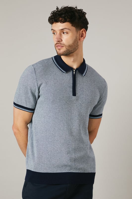 Birdseye knitted texture for a sophisticated look
        Contrasting collar and cuffs for a smart finish
        Quarter-zip neckline for adjustable comfort
        Short sleeves ideal for warmer weather
        Versatile design suitable for various casual occasions
    
    This Maine birdseye knitted polo shirt combines comfort with style, making it a versatile addition to your wardrobe. The textured knit adds depth and interest to the garment, while the contrasting collar and cuffs create a refined edge. Perfect for casual outings, this polo can be effortlessly styled for a range of events. Pair it with dark trousers and white trainers for a smart-casual look ideal for family gatherings or weekend brunches. The quarter-zip neckline allows for customisable comfort, adapting to your preference and the weather. Made from 100% cotton, this polo ensures breathability and ease of care, making it a practical choice for the modern man who values both style and functionality. Whether you're heading to a casual meet-up with friends or a relaxed day out, this Maine polo will keep you looking polished without compromising on comfort.