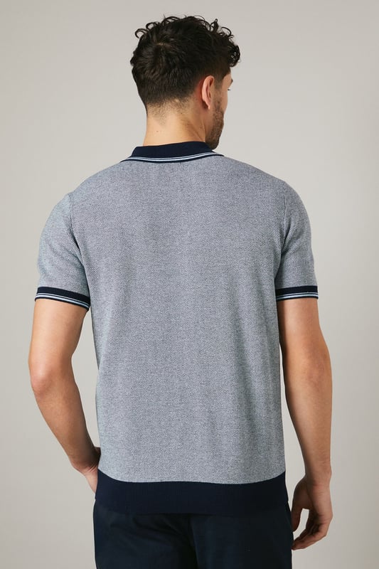 Birdseye knitted texture for a sophisticated look
        Contrasting collar and cuffs for a smart finish
        Quarter-zip neckline for adjustable comfort
        Short sleeves ideal for warmer weather
        Versatile design suitable for various casual occasions
    
    This Maine birdseye knitted polo shirt combines comfort with style, making it a versatile addition to your wardrobe. The textured knit adds depth and interest to the garment, while the contrasting collar and cuffs create a refined edge. Perfect for casual outings, this polo can be effortlessly styled for a range of events. Pair it with dark trousers and white trainers for a smart-casual look ideal for family gatherings or weekend brunches. The quarter-zip neckline allows for customisable comfort, adapting to your preference and the weather. Made from 100% cotton, this polo ensures breathability and ease of care, making it a practical choice for the modern man who values both style and functionality. Whether you're heading to a casual meet-up with friends or a relaxed day out, this Maine polo will keep you looking polished without compromising on comfort.